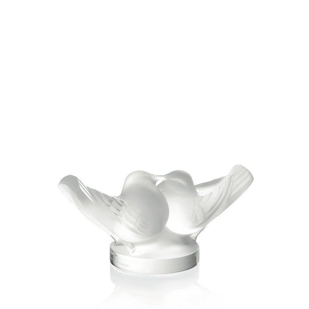 White ceramic sculpture of two birds on a white background