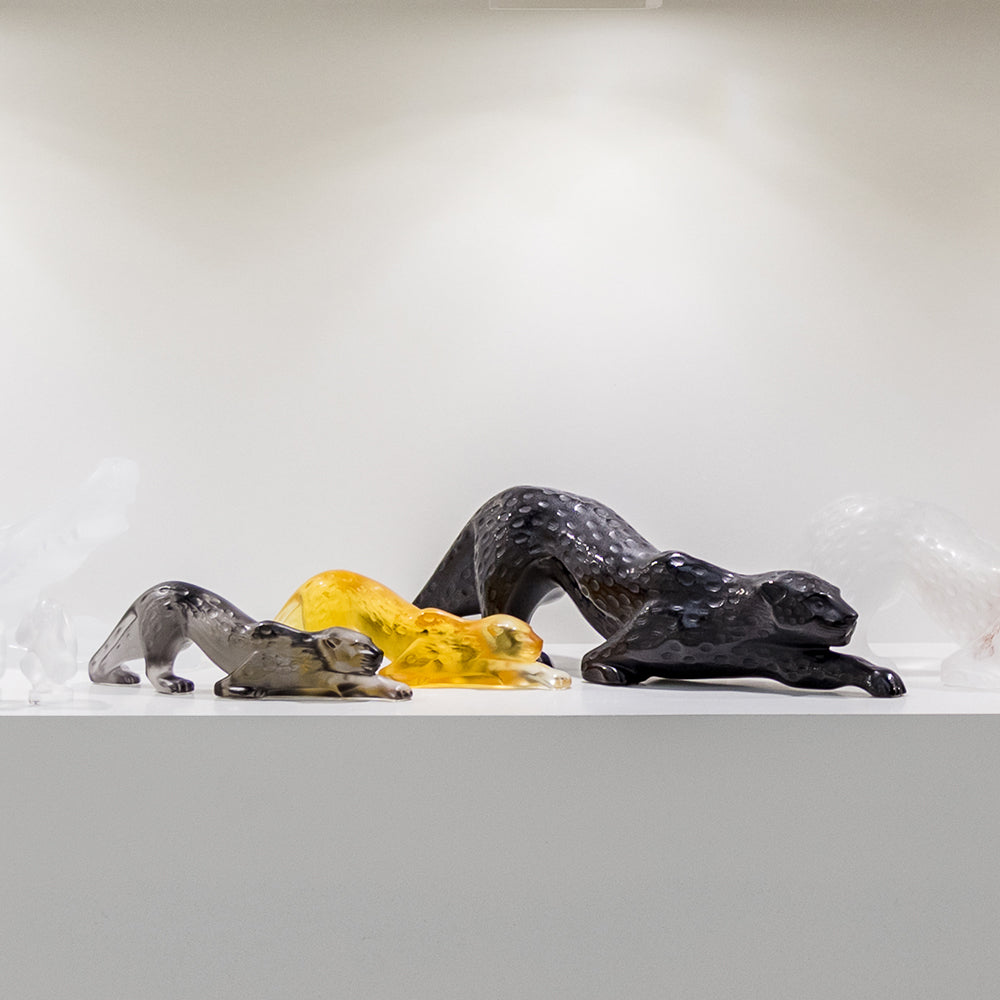 Three glass animal figurines on a white surface with a light gray background