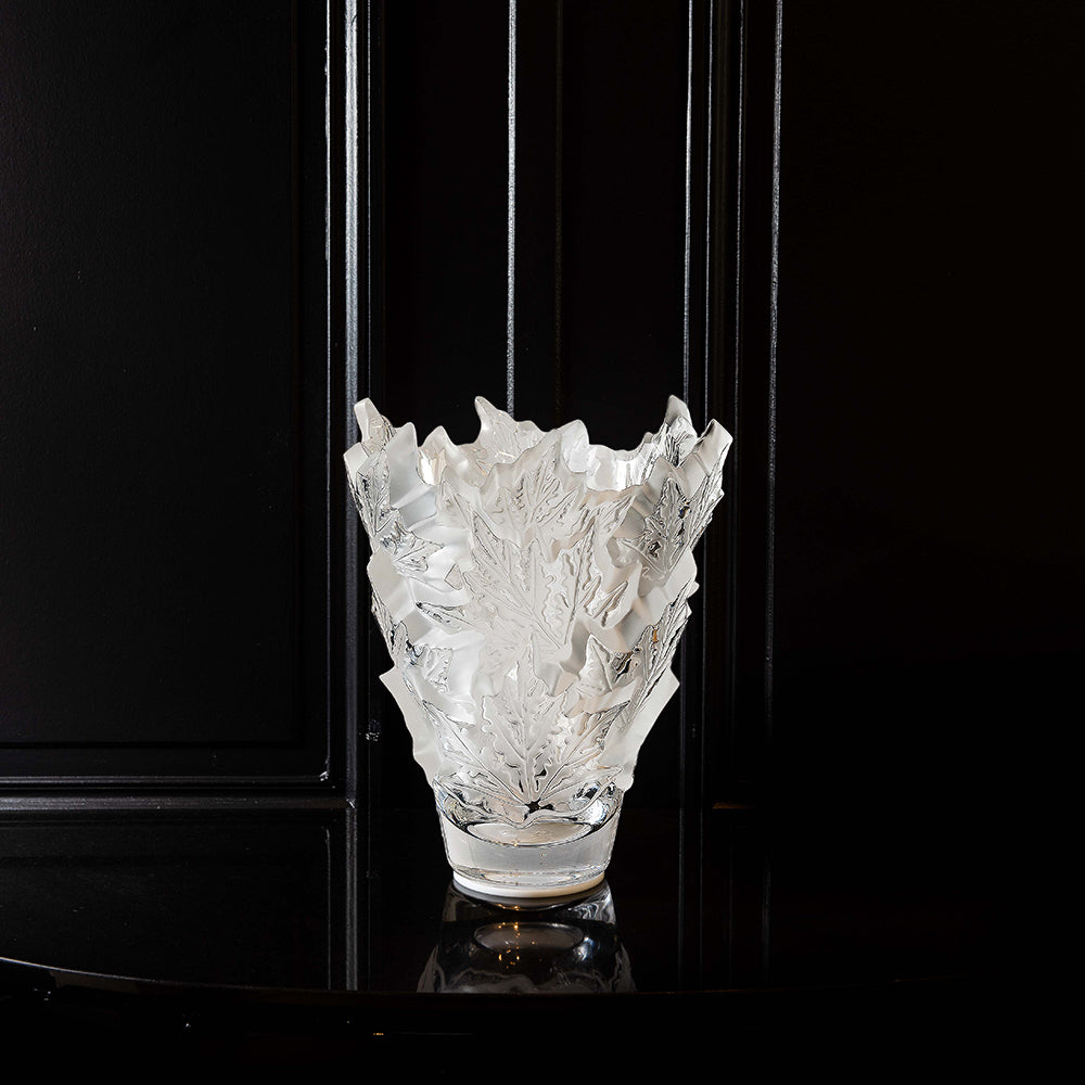 Decorative glass vase with intricate design on a black background