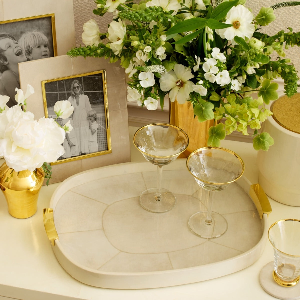Beige tray with gold handles on a white background