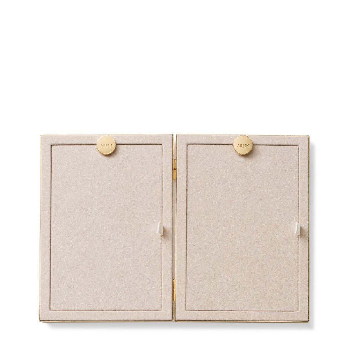 A minimalist two-door jewelry display box in a light beige textured material with small round gold-tone buttons and a gold hinge, shown open against a white background.