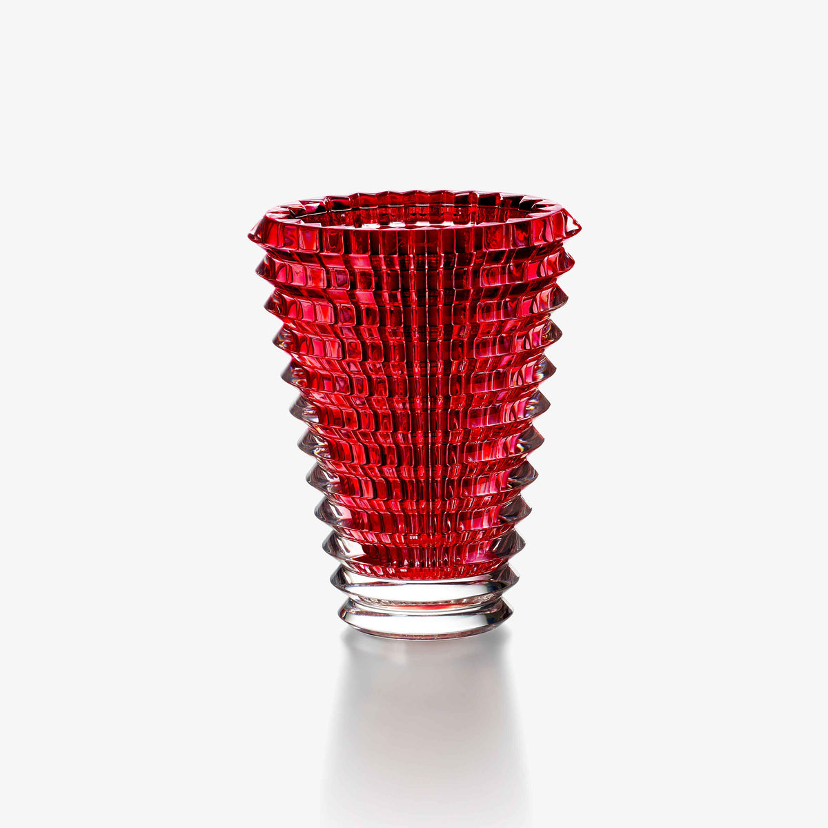 Red glass vase with textured design on a white background