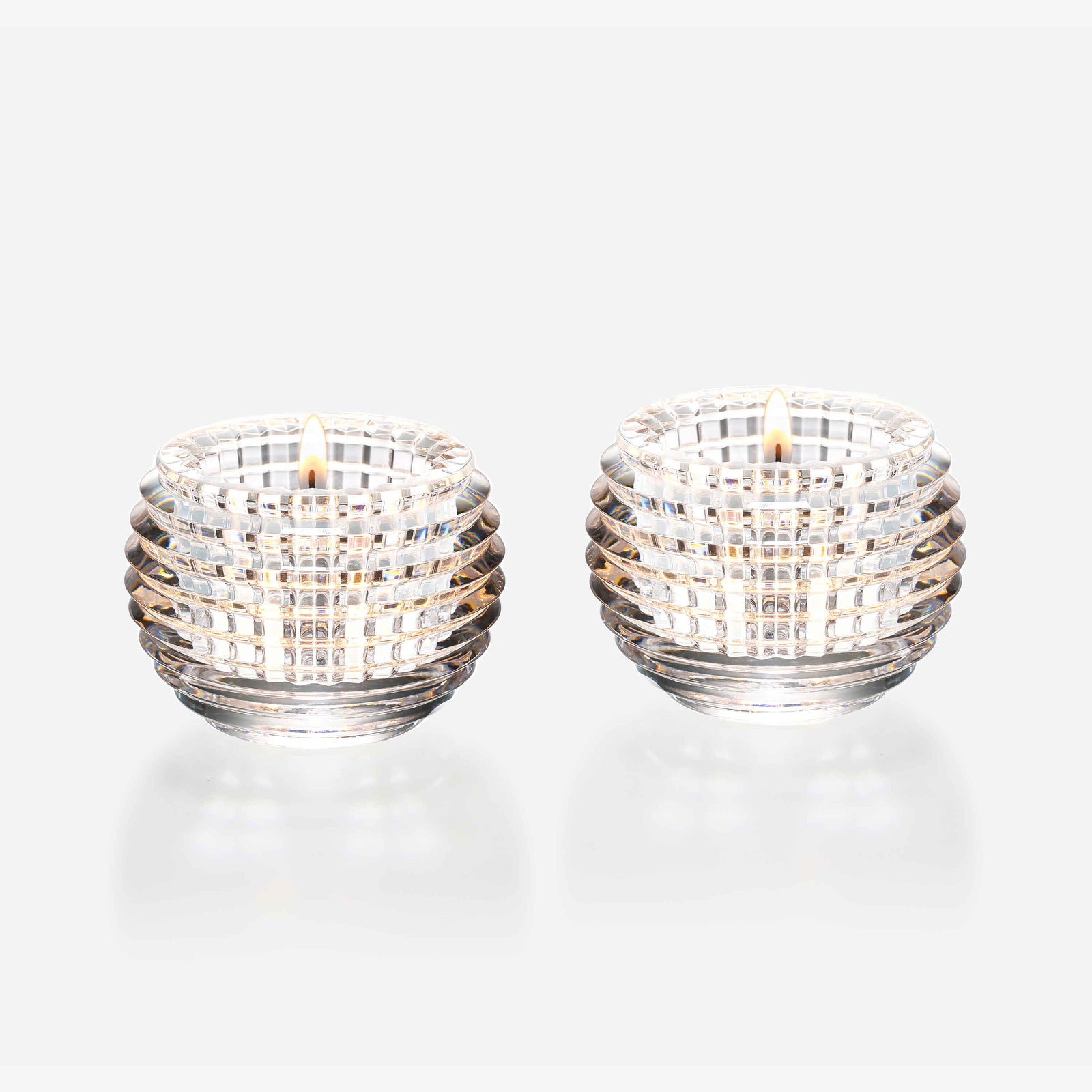 Two crystal candle holders on a white background