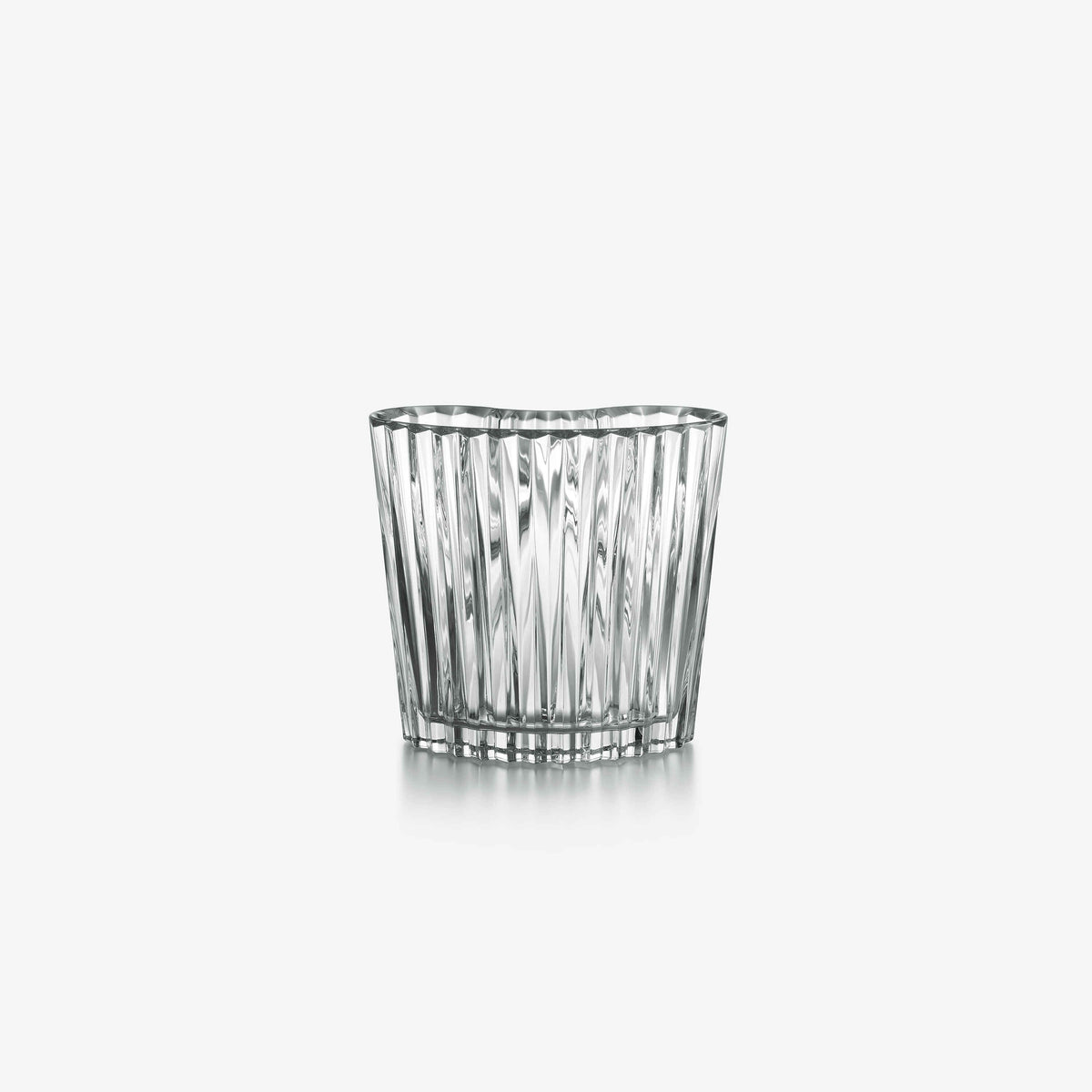 Clear crystal tumbler with vertical ridges on a white background