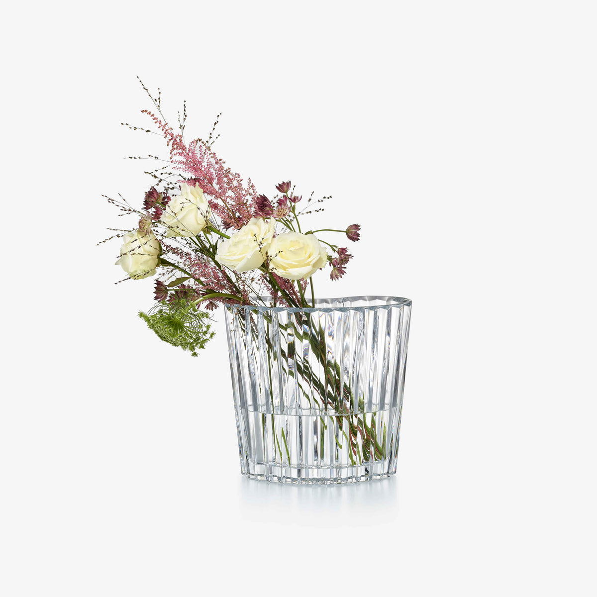 Clear crystal vase with a bouquet of flowers on a white background