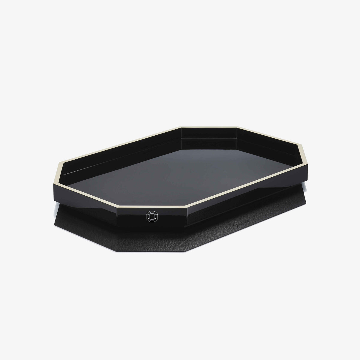 Black octagonal tray with gold rim on a white background