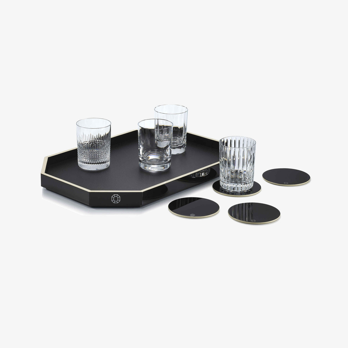 Black tray with four glasses and coasters on a white background