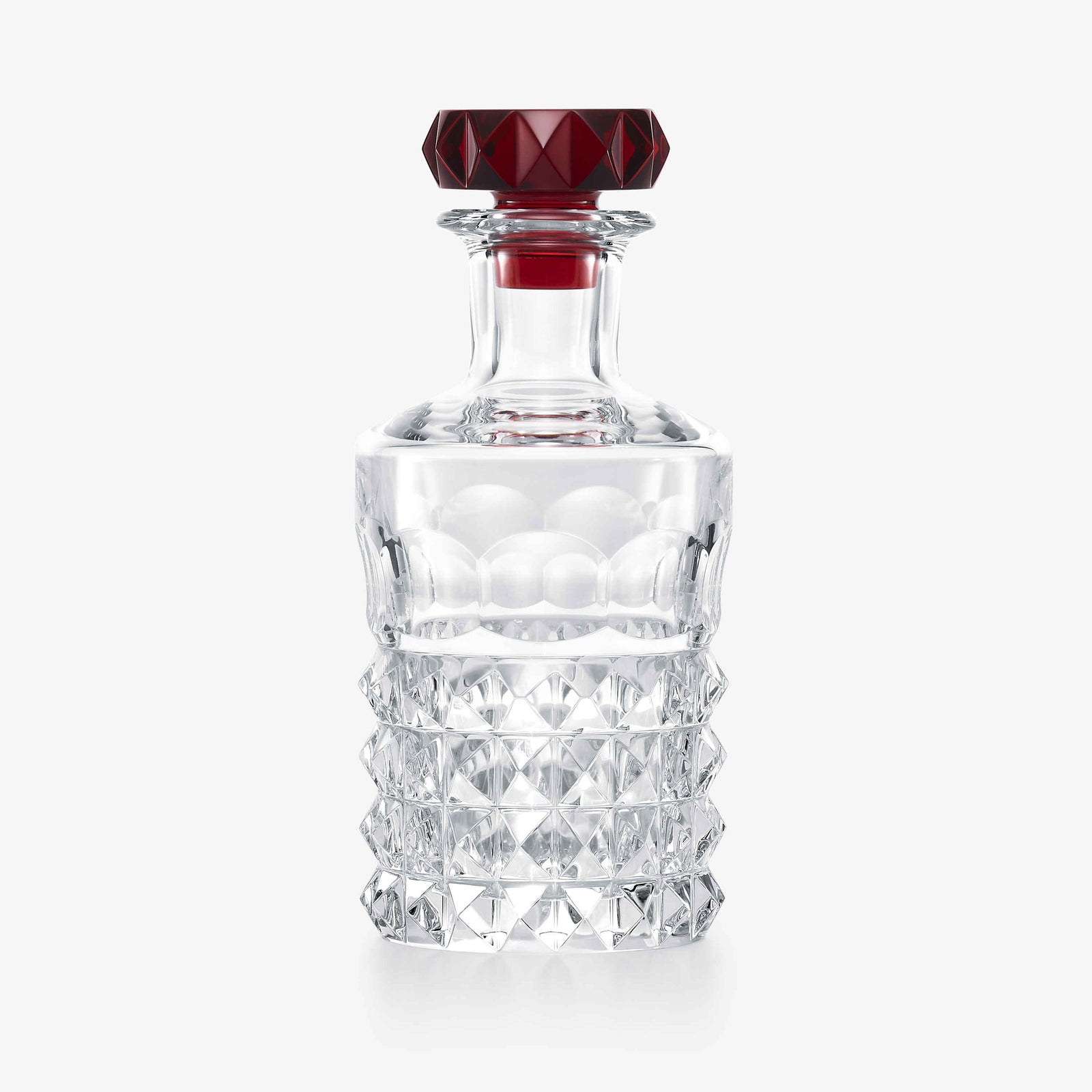 Clear crystal decanter with a red cap on a white background