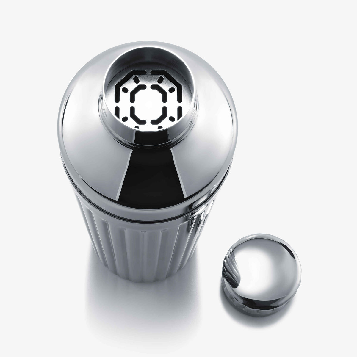 Chrome cocktail shaker with Hawthorne strainer on a white background