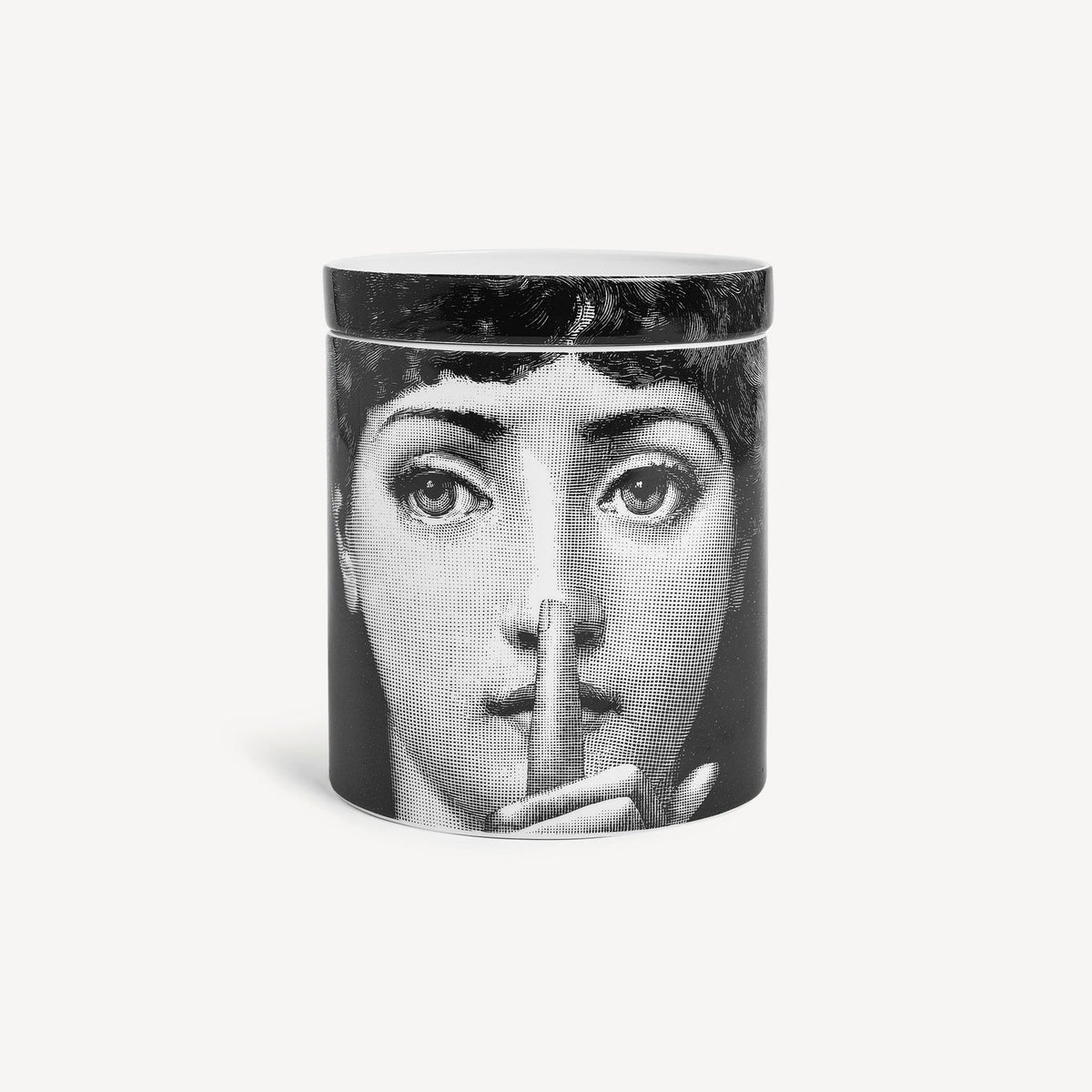 Candle with a design of a face on a white background