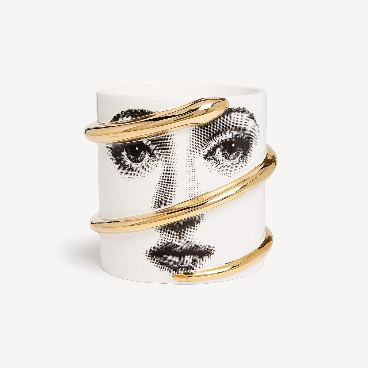 Ceramic candle holder with gold accents featuring a face design on a white background