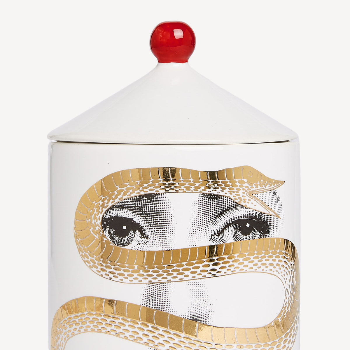 Ceramic jar with a face design and gold accents on a white background