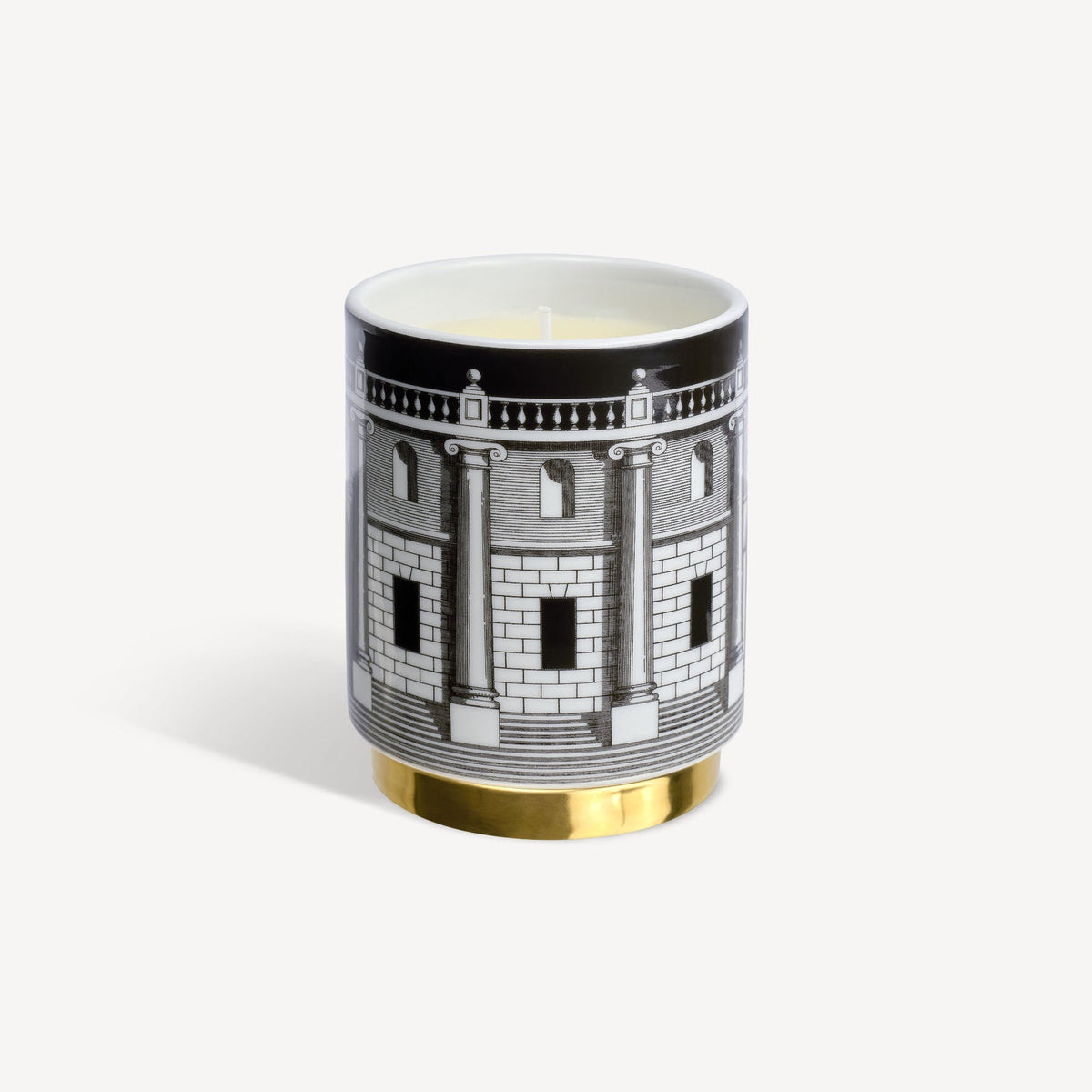 Candle in a decorative container with architectural design on a white background