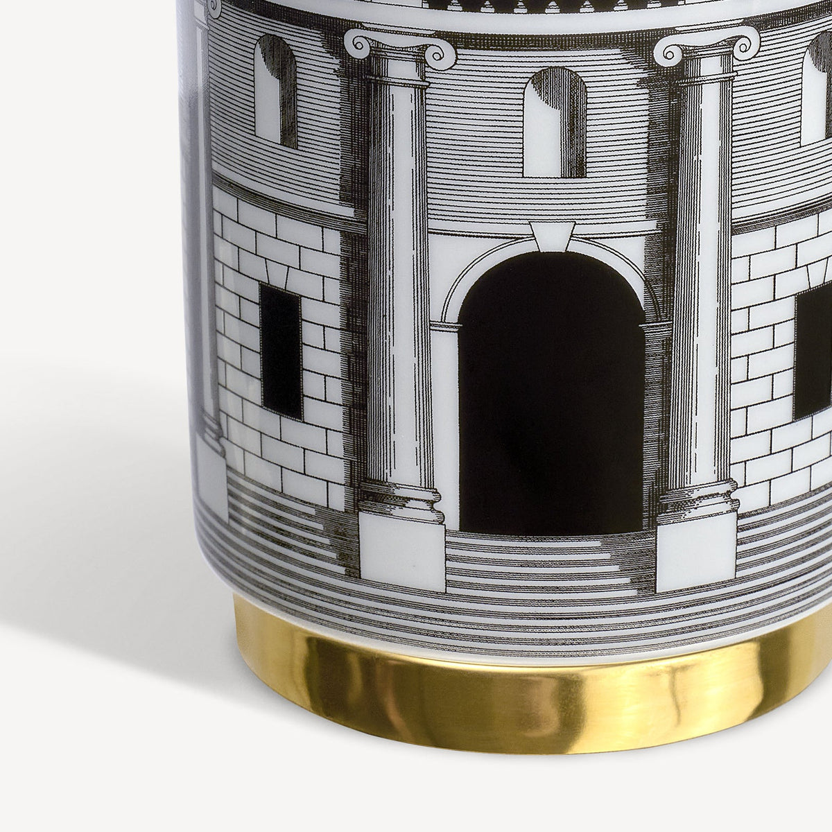 Decorative vase with architectural design and gold base on a white background