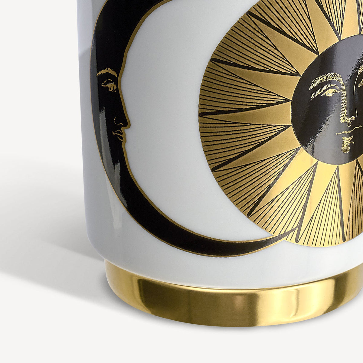 Decorative mug with gold and black design on a white background
