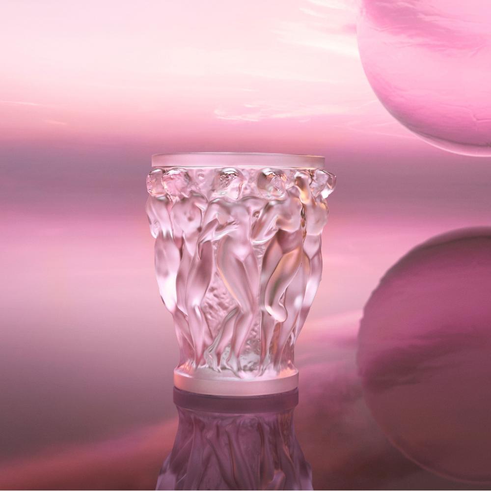 Decorative glass vase with artistic design on a pink background