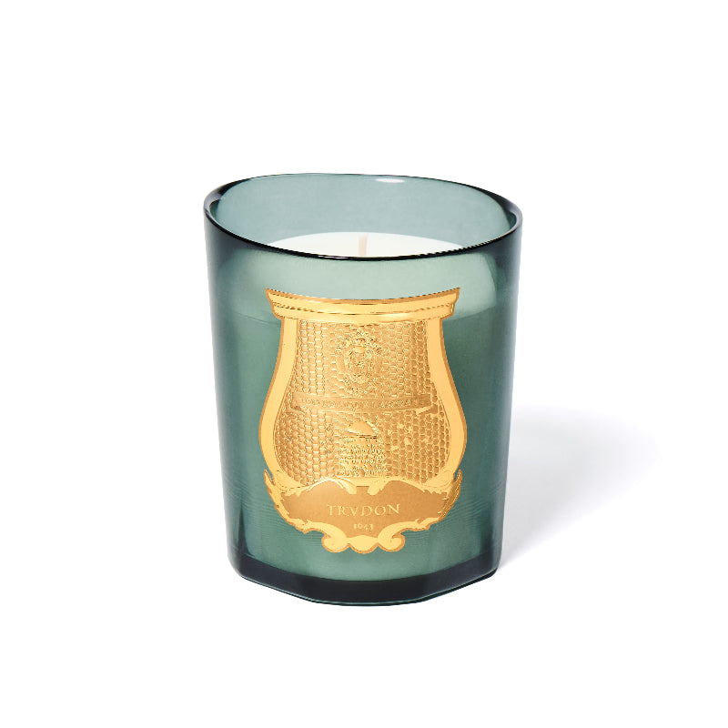 Green candle with gold emblem on a white background