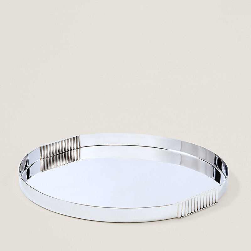 Silver round tray on a beige background