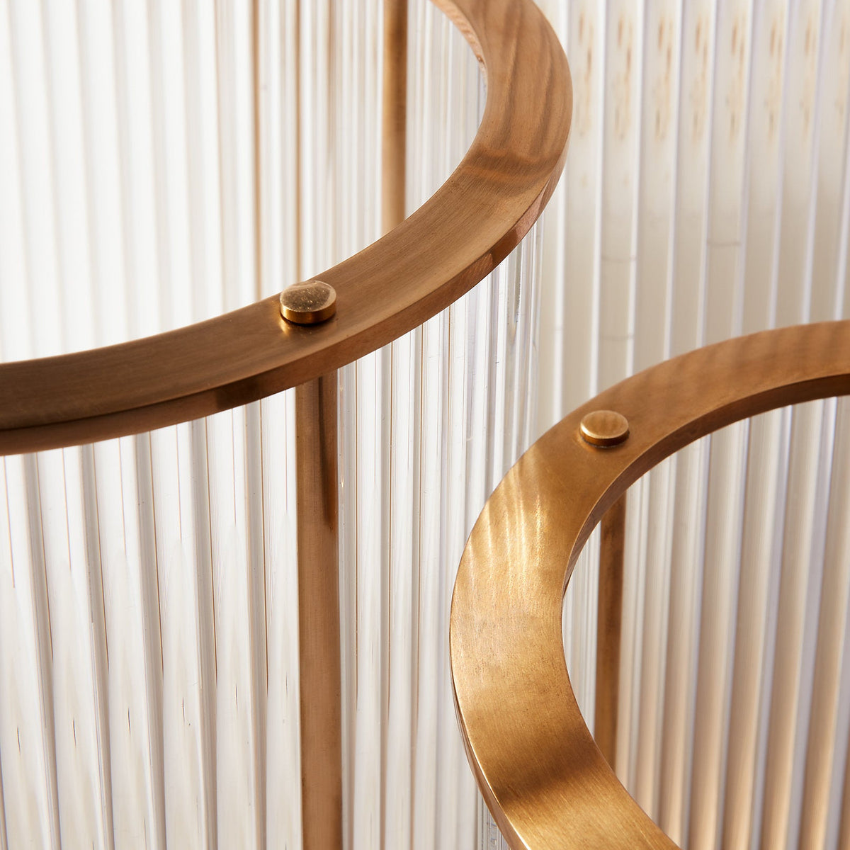 Gold circular metal frame against a white striped background