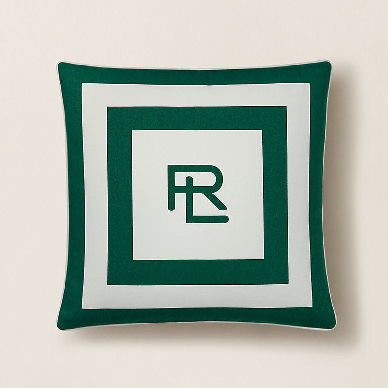Green pillow with a logo on a beige background