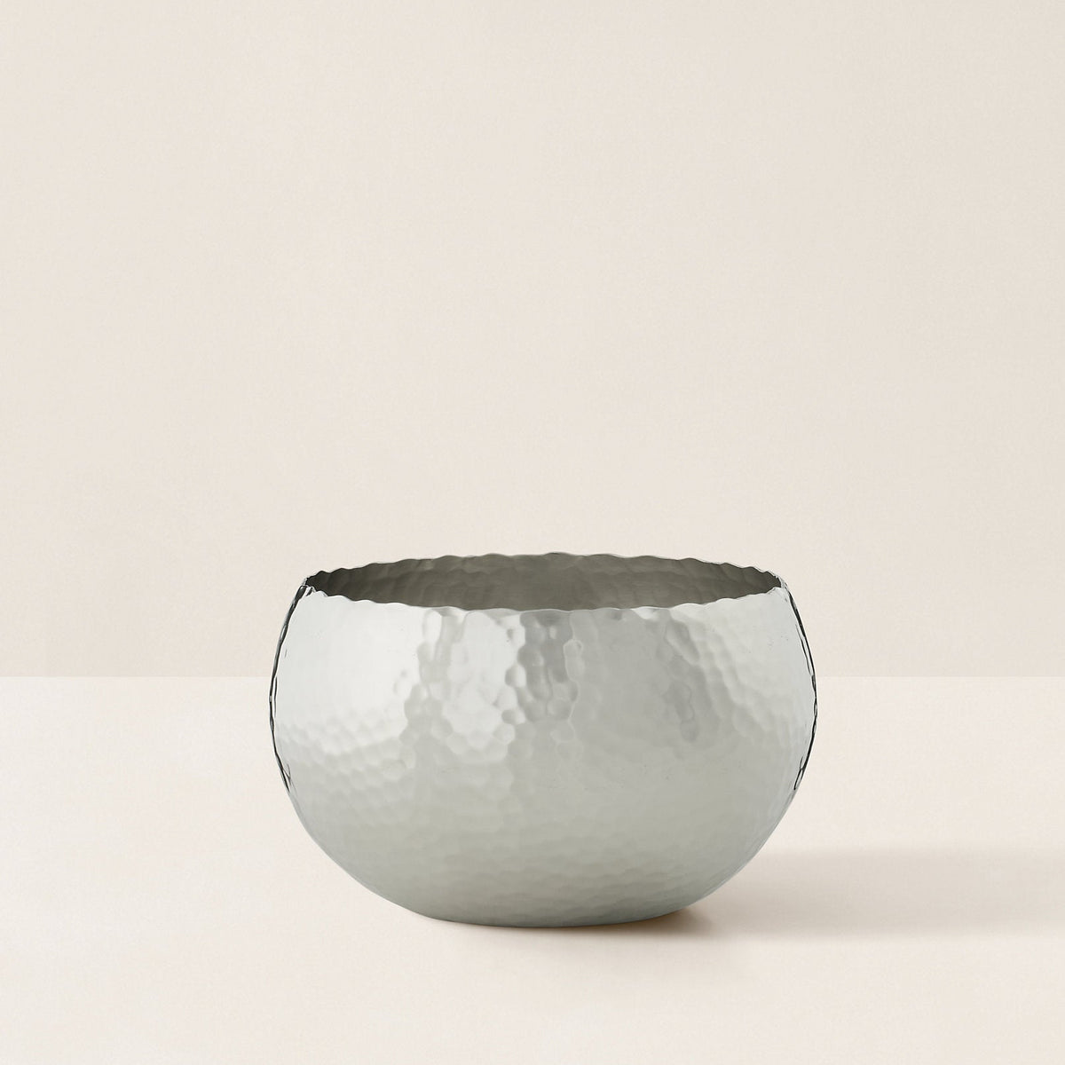 Decorative bowl with textured surface on a light beige background