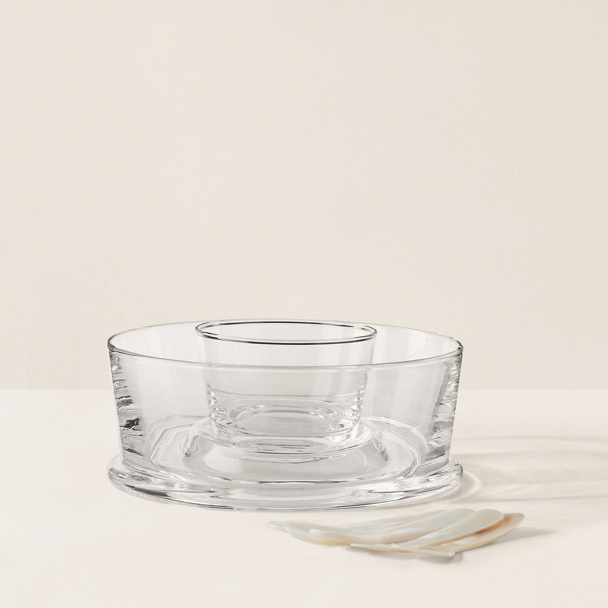 Clear glass bowl on a beige background