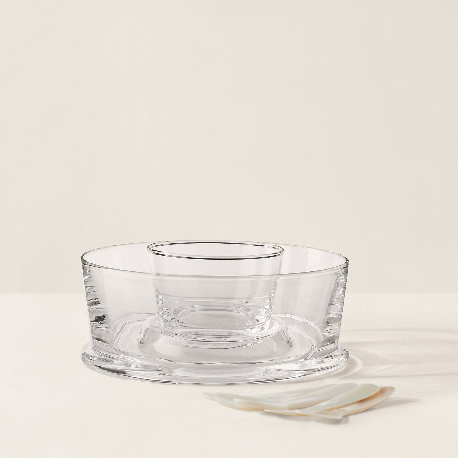 Clear glass bowl on a beige background