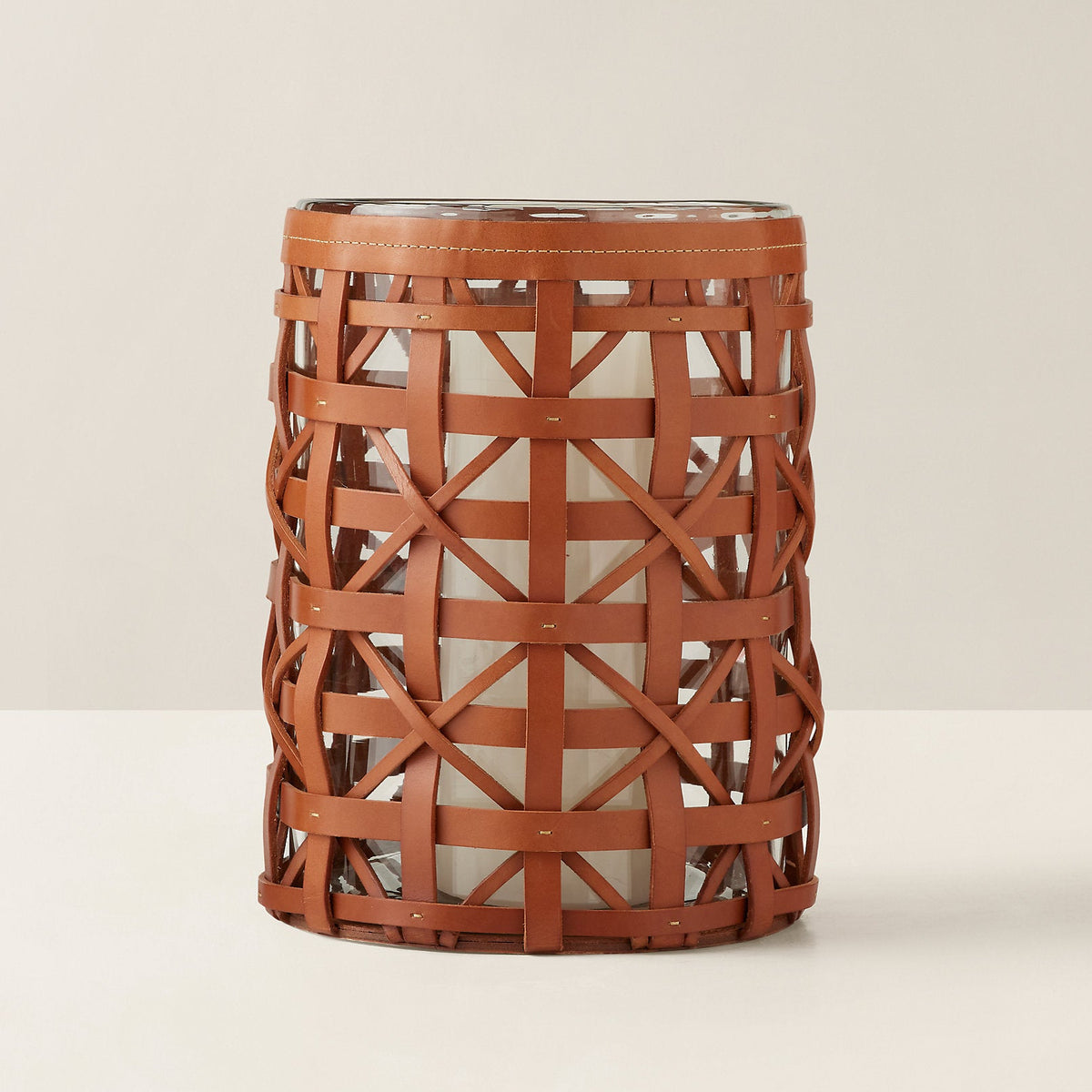 Decorative cylindrical vase with woven brown pattern on a beige background