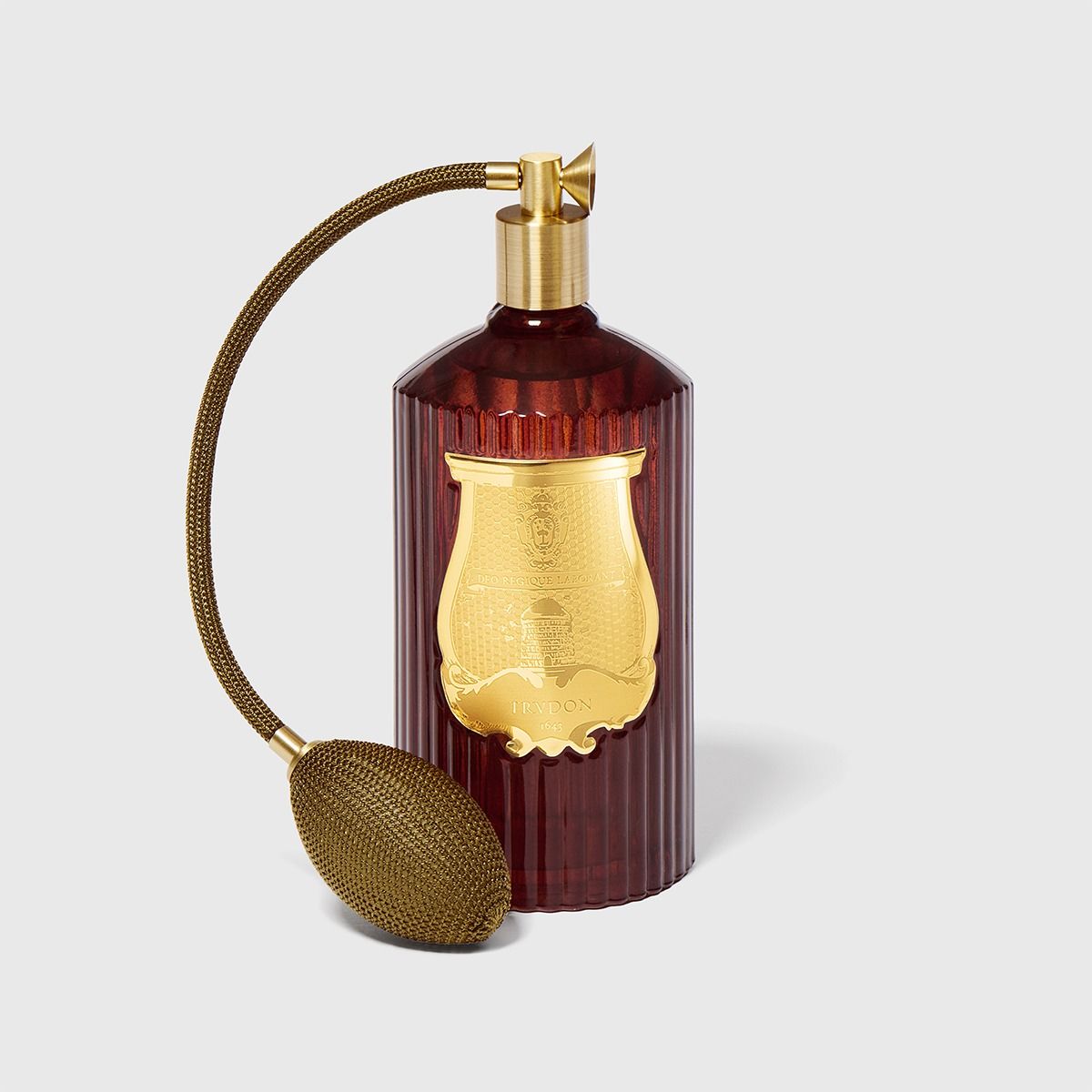 Decorative diffuser with gold accents and a matching box on a light gray background