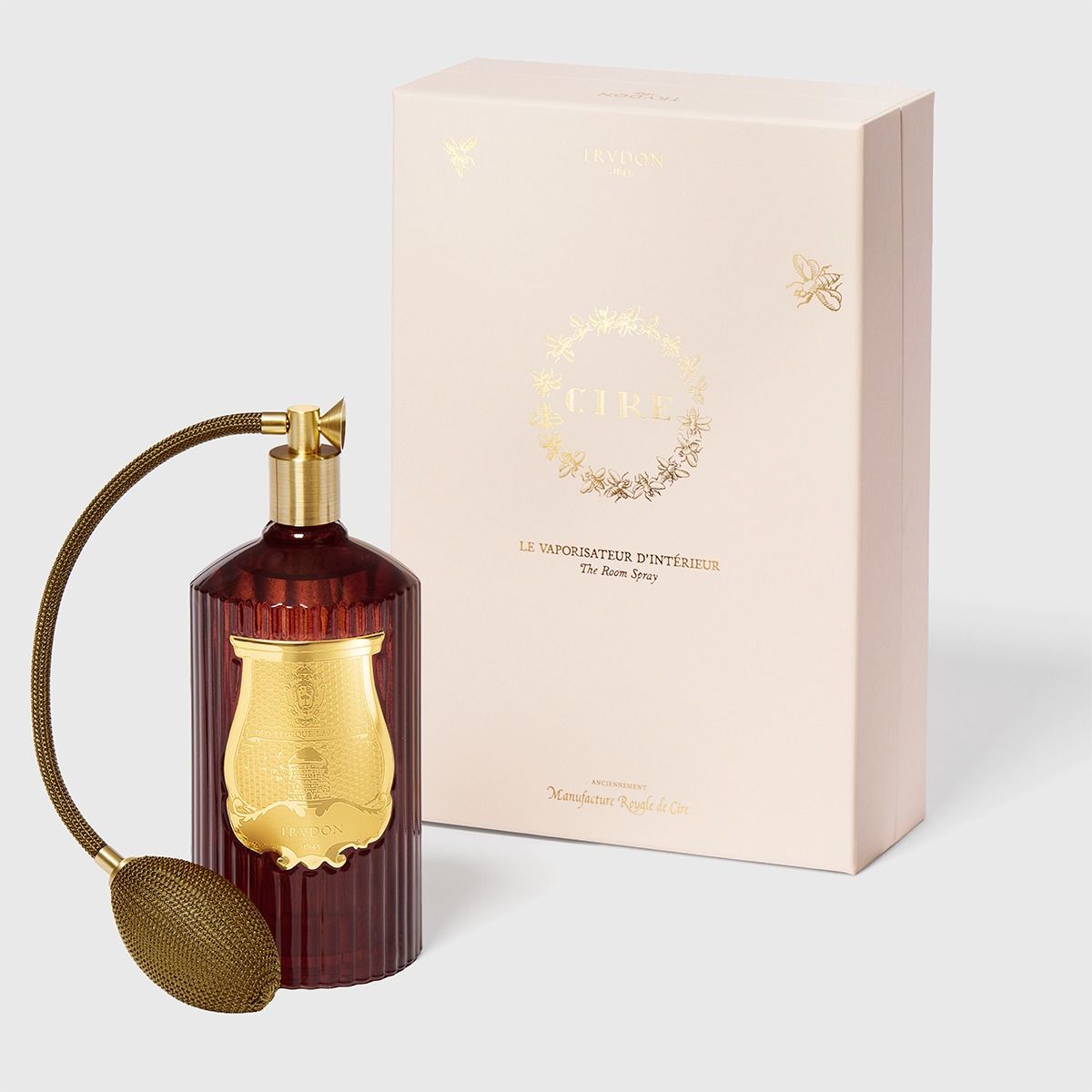 Decorative diffuser with gold accents and a matching box on a light gray background